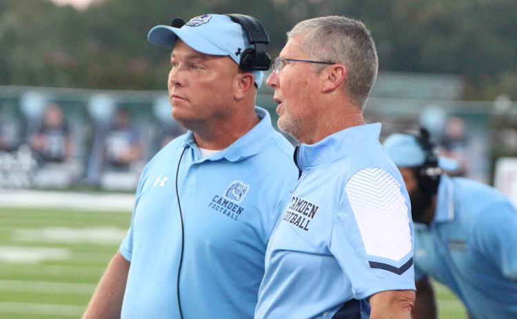 Camden County High School’s new head football coach, Jon Lindsey, left, discusses an on-field adjustment with former football coach Jeff Herron during a 2023 football game. Lindsey was named the new football coach of the program Friday.