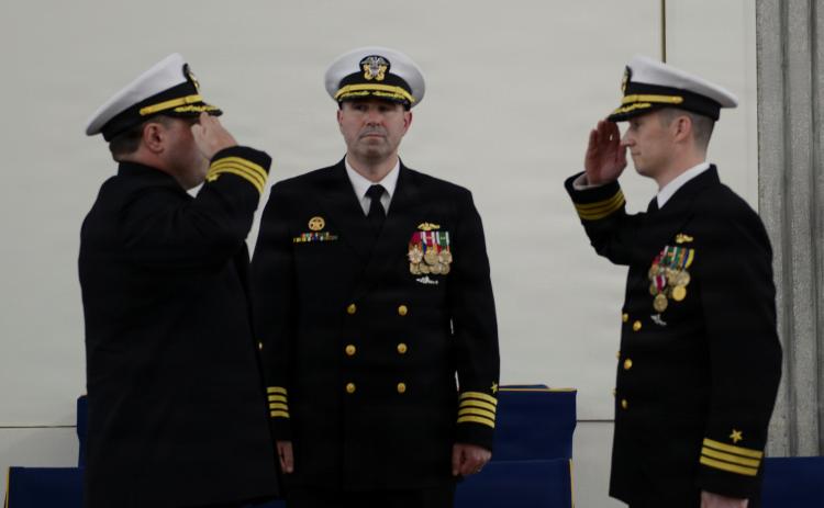 U.S. Navy Cmdr. Brian Ross, right, relinquishes command of the Ohio-class ballistic missile submarine, USS West Virginia (Gold), to Cmdr. Scott J. Tedrick during a change of command ceremony at Naval Submarine Base Kings Bay.