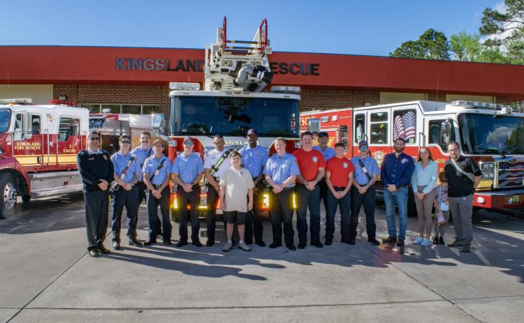 Kingsland Deputy Fire Chief Bill Carreira, left, Alex Gonzalez, seventh from left, Kingsland Mayor Grayson Day Jr., fourth from right, and others are surrounded by the rescue team from Kingsland Fire Rescue Station 4.