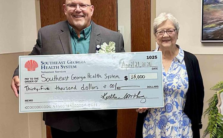 Southeast Georgia Health System Vice President and Administrator Glenn Gann, left, and Volunteer Services President Peggy Tuten pose for a photo with a check from Volunteer Services.
