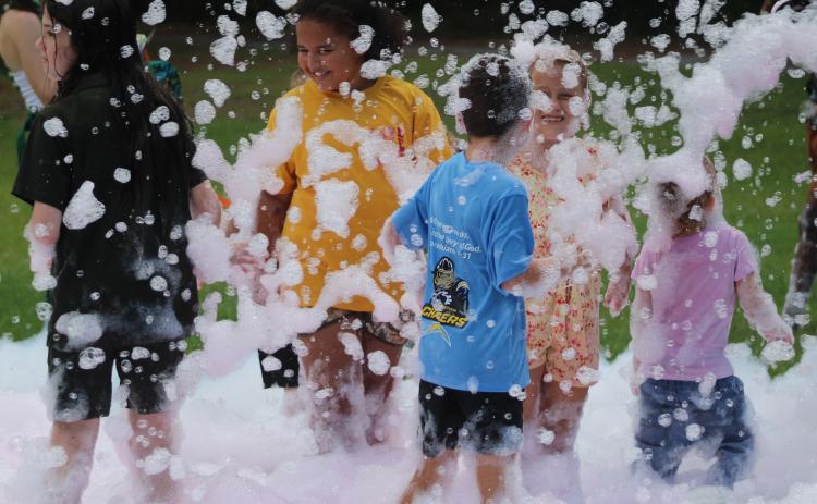 Children play in the foam machine Tuesday during Camden Family Connection’s annual Party in the Park at Crooked River State Park.