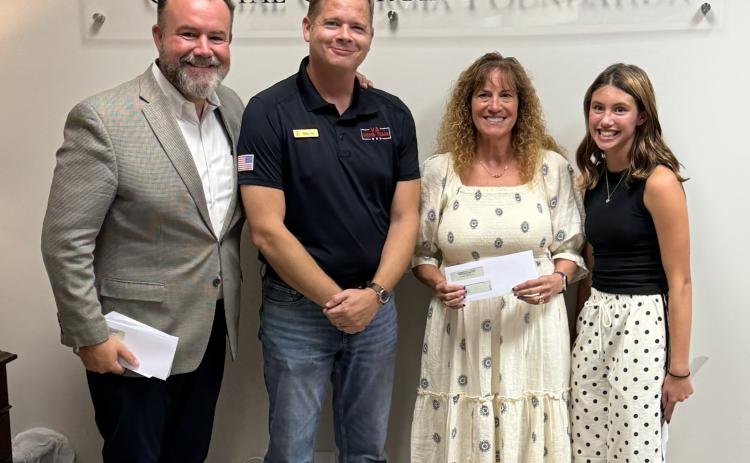 Keeva Kase, from left, executive director of the Communities of Coastal Georgia Foundation; Mitch Blyler, past president of the Rotary Club of Camden County; Cheryl Aston, Wee Read program coordinator and local Kiwanis Club of St. Marys member; and Celia Young, founder of Helping People in Need pose for a photo after Young donated $500 to the local Wee Read program.