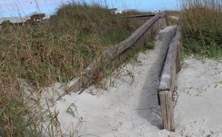 While the ADA ramp and Mobi-Mat that provide access to the beach at Main Beach are in good shape, allowing those in wheelchairs and with limited mobility to get out on the beach, the ADA ramp at Seaside Park has been overtaken by the dune. JULIA ROBERTS/NEWS-LEADER