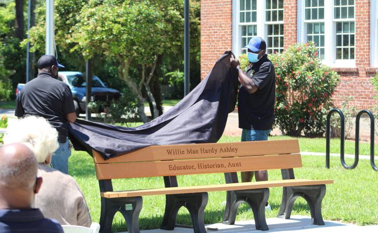 Members of the Elm Street Sportsman Association unveil a bench dedicated to Willie Mae Hardy Ashley at the Peck Center. Ashley taught in Nassau County Schools for 35 years, including then-segregated Peck High School.