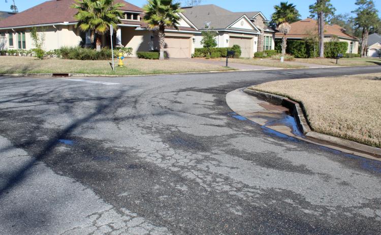 On a sunny, dry day, there is water seeping out of the pavement on Spanish Way in the Isle de Mai subdivision. The city of Fernandina Beach filed a lawsuit against CPH Engineering, claiming the company built the road too low, causing water to damage the street. CPH offered the city $80,000 in cash and in-kind services to settle the matter, which the City Commission rejected.