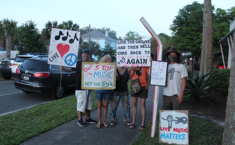 Picketers stood outside Fernandina Beach City Hall Tuesday as the City Commission discussed changes to the city’s noise ordinance. Some speakers at the meeting said they want a committee created to help craft an ordinance that would work for musicians, business owners and residents.