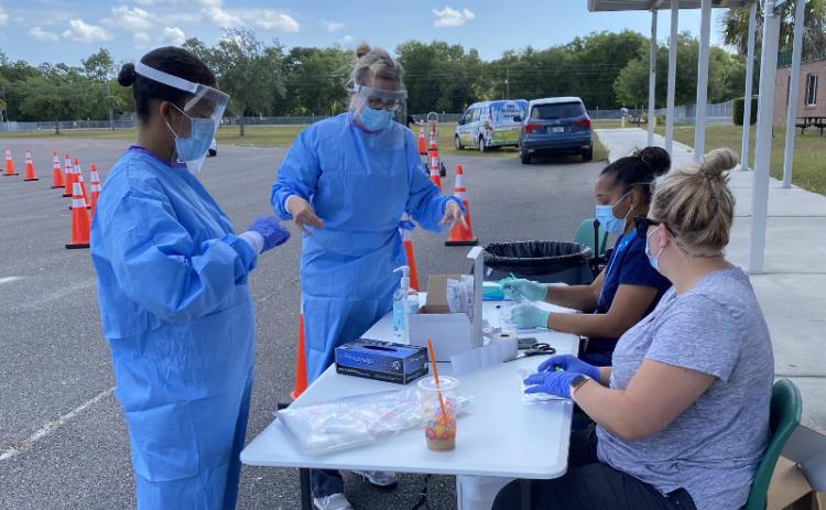 Florida Department of Health – Nassau County workers tested residents at a drive-thru COVID-19 testing site in May. JULIA ROBERTS/NEWS-LEADER