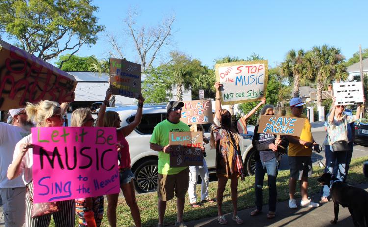 People stand outside Fernandina Beach City Hall in support of live music downtown. City commissioners passed first reading of a law they hope will allow music to be performed while avoiding disturbing downtown residents.