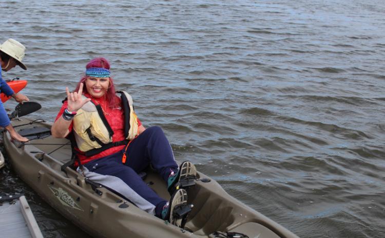 Mark Bullington with Amelia Kayak Excursions shows Jennifer Tozzo how to guide her modified kayak. The Hobie kayak has been outfitted to allow Tozzo to move it through the water with her legs instead of paddles. JULIA ROBERTSON/NEWS-LEADER