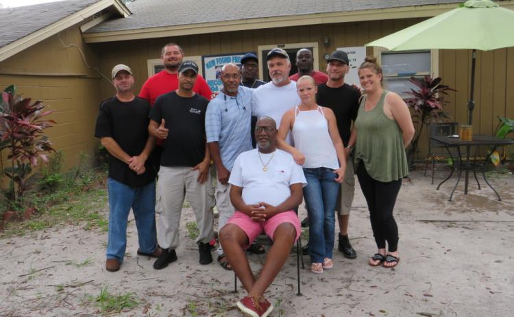 Henry Green sits surrounded by some of the people he has helped through the Grace and Gratitude Sober Living program. He and Dr. Jeff Blyth are both recovering addicts and fighting the city of Fernandina Beach to keep the four houses that comprise Grace and Gratitude’s facilities open. JULIA ROBERTS/NEWS-LEADER