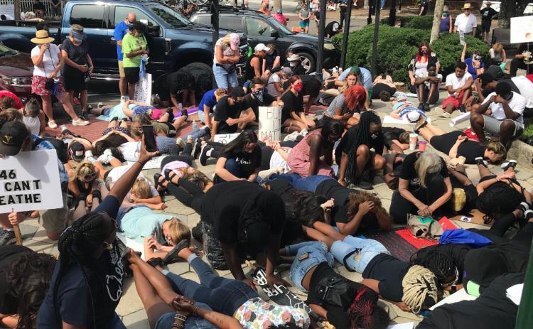 In a gesture of solidarity, protesters took a knee, observed silence or laid on the ground in the same position as George Floyd for eight minutes and 46 seconds, the length of time a Minneapolis police officer knelt on Floyd’s neck while other officers and bystanders watched. MIKE LEARY/SPECIAL FOR THE NEWS-LEADER