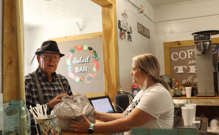 Megan Arnold readies a food order for Norman Mizell at Callahan Country Kitchen.