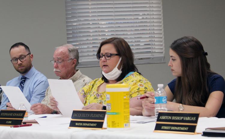 Town Clerk Stephanie Knagge reads her letter of resignation aloud Monday evening. Her resignation is effective March 31. Town Council President Ken Bass reads along in the background as interim Town Attorney Christian Waugh listens.