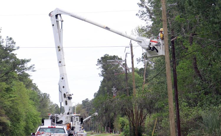 A crew works to replace poles along Lem Turner Road in Callahan March 29.