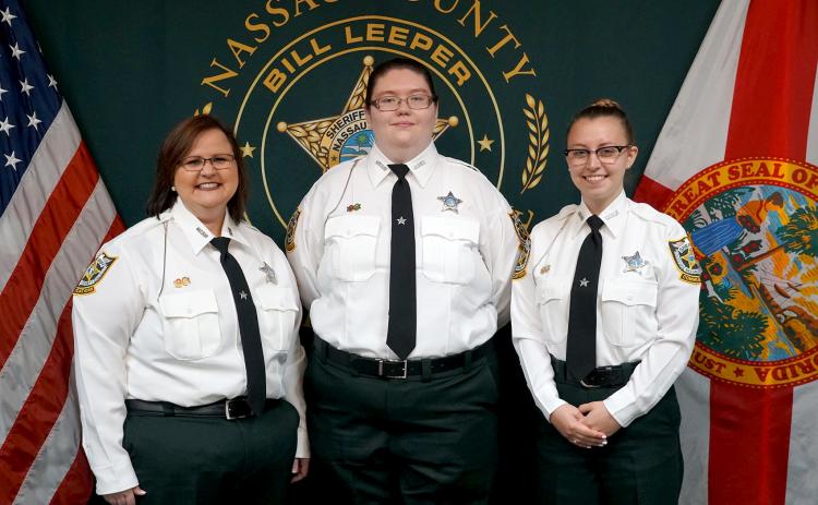 Stephanie Knagge, April Persinger and Alexis Baird pose after swearing in as new dispatchers with the Nassau County Sheriff’s Office.