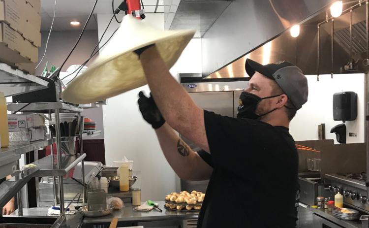 Josh Sheppard has worked for Coastal Pizza for just under four years, coming with the company from Yulee to their new Amelia Island location. Twirling pizza dough into the air, he said he has fun at work, adding, “I love what I do.” JULIA ROBERTS/NEWS-LEADER