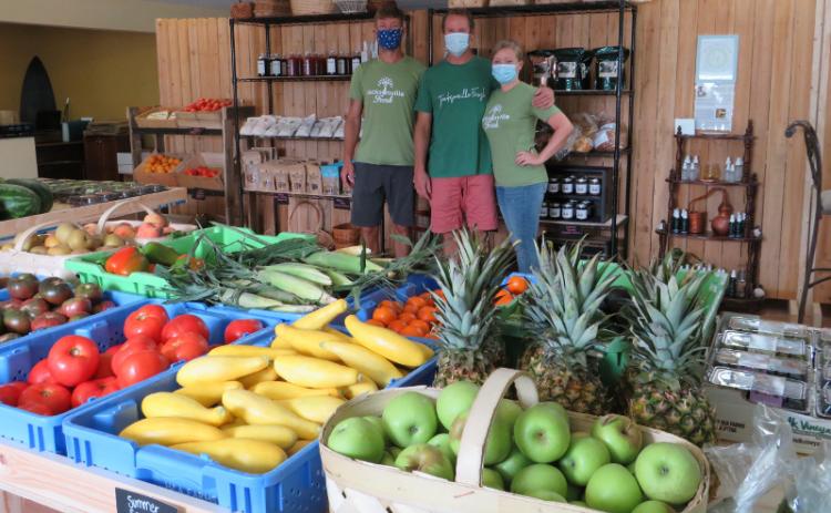 Family friend Bradley Brown helps Glenn and Jessie Bourquin supply fresh produce and farm products to Camden, Nassau, and Duval counties through their business, Jacksonville Fresh, which recently opened a store in Fernandina Beach. JULIA ROBERTS/NEWS-LEADER