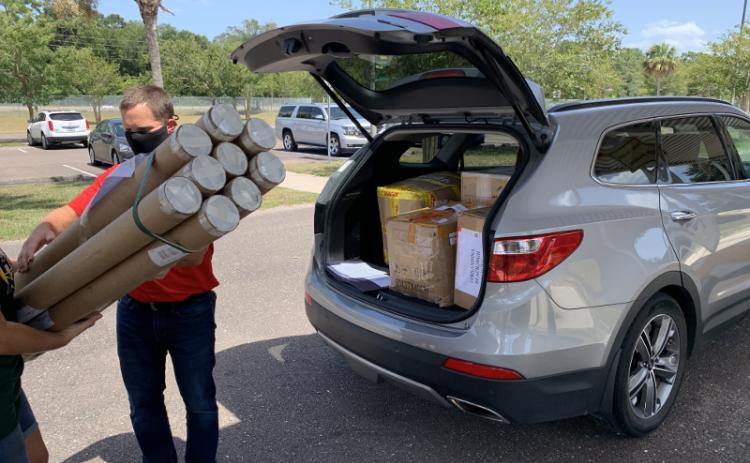 Jeffrey Brewer, STEM coordinator at Naval Submarine Base Kings Bay, Ga., unloads some of the thousands of dollars worth of equipment donated recently by the Navy to the Nassau County School District. SUBMITTED
