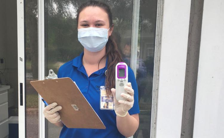 Osprey Village staff member Caitlyn Lee screens people coming into the community as part of measures that have helped the community maintain zero positive coronavirus tests of staff and residents. SUBMITTED PHOTO