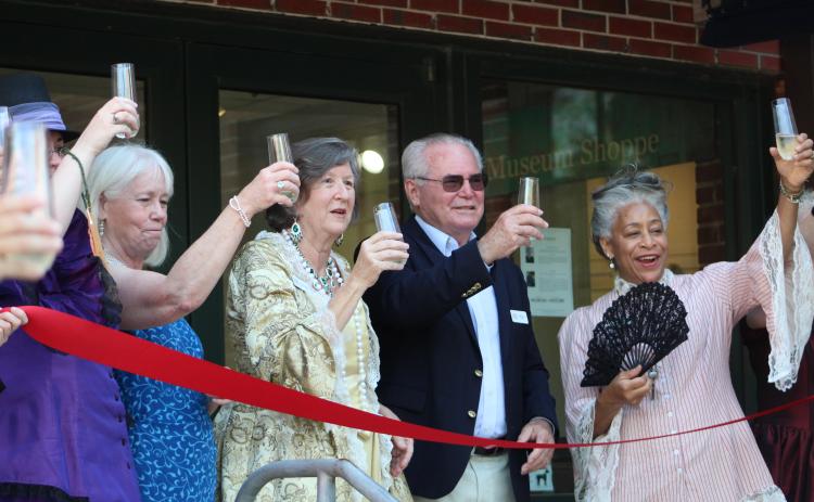 Amelia Island Museum of History employees and board members toast the grand reopening of the museum.