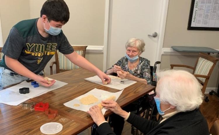 Yulee Middle’s Asher Conway spends time with assisted living residents at Osprey Village.