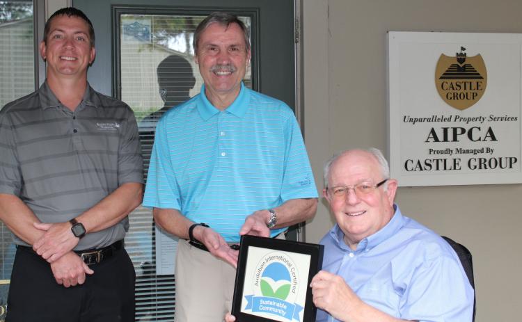 Amelia Island Plantation Community Association Director of Facilities and Maintenance Kenny Walczak, from left, AIPCA Executive Director Tim Digby and Amelia Island Plantation Foundation President Bob Schmonsees pose with the AIP’s Audubon International Sustainable Community Certificate.