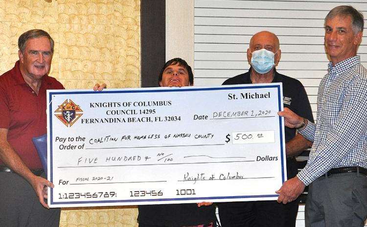 Knights Bob Gerth, Breant Dickerson and Kenny Dalton present a check to Mark Avakian of the Coalition for Homeless of Nassau County. JACK DEACON/SPECIAL