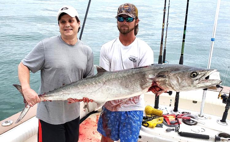 Cliff Baker and mate Trent Wainwright are pictured with Baker’s 48-pound kingfish caught aboard Capt. Allen Mill’s charter fishing boat, the Wahoo II, on Saturday. SPECIAL