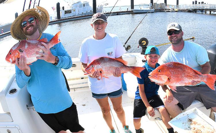 William Boyle, Julie, Breck and William Benton with a nice catch of red snapper, left. Capt. Bryce Schmidt cleans a nice catch of red snapper, right. TERRY LACOSS/SPECIAL