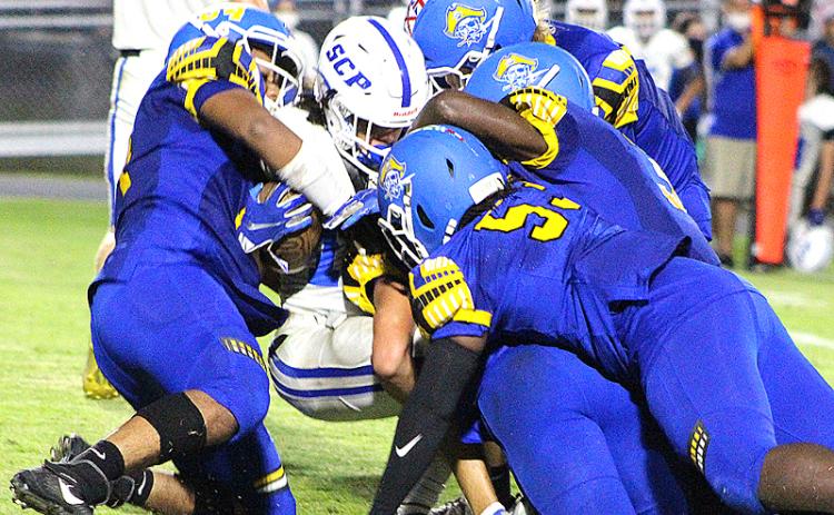 The Pirate defense wraps up a Blue Devil Friday night at Pirate Field. BETH JONES/NEWS-LEADER