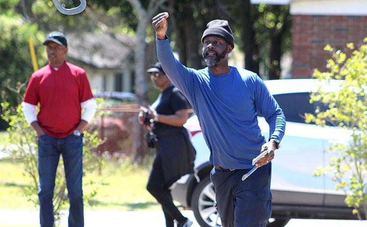 Teddy White competes in the inaugural horse shoe tournament Saturday at the MLK Jr. Center. He and teammate Everette Way took first place.