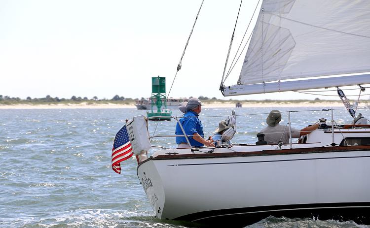 Sea Esta skipper Glen Stettler, at the helm on left, and crew keeping an eye on traffic and markers along the race course on Saturday.