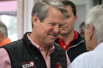 Gov. Brian Kemp speaks to a supporter prior to his breakfast rally in downtown St. Marys.