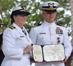 Capt. Kristen Serumgard, chief of the U.S. Coast Guard Atlantic Area Operational Forces, honors Lt. Cmdr. Mark Ketchum, who led the Maritime Safety and Security Team Kings Bay.