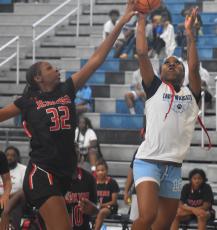 The Lady Wildcats’ Akeelah Bryan tries to get a shot away against Jenkins’ Heaven Arkwright. (Andy Diffenderfer, Tribune & Georgian)