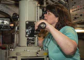 3M Senior Vice President and Global Chief Information Security Officer Carolann Shields looks through the periscope of the Ohio-class ballistic missile submarine USS Wyoming (SSBN 742) during a tour as part of the Joint Civilian Orientation Conference.