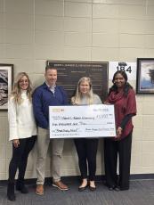 Ashley Fey, from left, McDonald’s owner and operator Adam Fey, David L. Rainer Elementary School teacher and grant applicant Julia L. Baude and Principal Deborah Milstead show off a grant the school received.