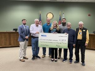 County Administrator Shawn M. Boatright, Commissioner Lannie Brant, Chairman Ben Casey, Grants Manager Julie Haigler, and Commissioners Trevor Readdick, Martin Turner and Jim Goodman show off the grant received to fund an internship program with the county government.