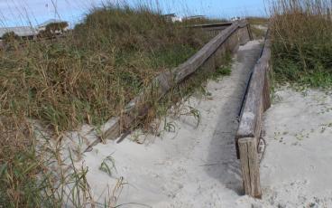 While the ADA ramp and Mobi-Mat that provide access to the beach at Main Beach are in good shape, allowing those in wheelchairs and with limited mobility to get out on the beach, the ADA ramp at Seaside Park has been overtaken by the dune. JULIA ROBERTS/NEWS-LEADER