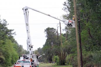 A crew works to replace poles along Lem Turner Road in Callahan March 29.