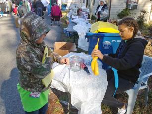 Cousins Dixie Conekin and Aliya Works volunteer at the Be the Change Northeast Florida, Inc. clothing giveaway Saturday. The duo assists at the non-profit’s events often. 