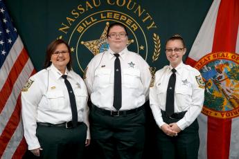 Stephanie Knagge, April Persinger and Alexis Baird pose after swearing in as new dispatchers with the Nassau County Sheriff’s Office. 