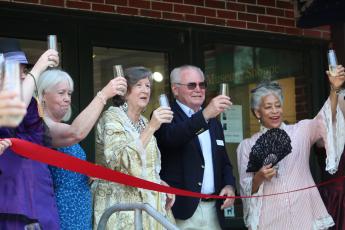 Amelia Island Museum of History employees and board members toast the grand reopening of the museum. 