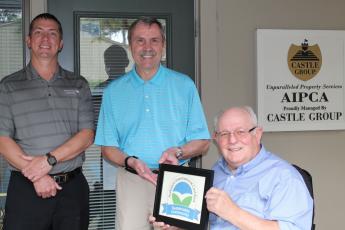 Amelia Island Plantation Community Association Director of Facilities and Maintenance Kenny Walczak, from left, AIPCA Executive Director Tim Digby and Amelia Island Plantation Foundation President Bob Schmonsees pose with the AIP’s Audubon International Sustainable Community Certificate.