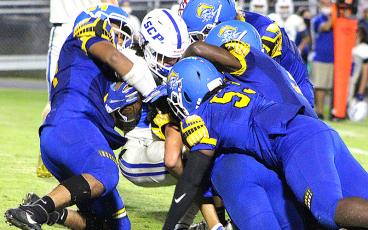 The Pirate defense wraps up a Blue Devil Friday night at Pirate Field. BETH JONES/NEWS-LEADER