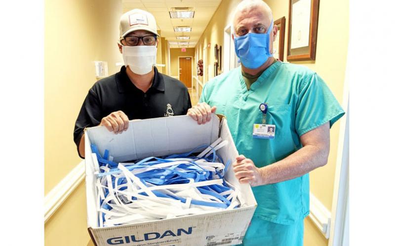 Lil Seabag in St. Marys used surgical materials to fabricate N95 masks for Southeast Georgia Health System medical personnel. Dr. Thomas Whitesell (right), chief of staff for Camden Campus, coordinated the project with business owner Jonathon Blount.