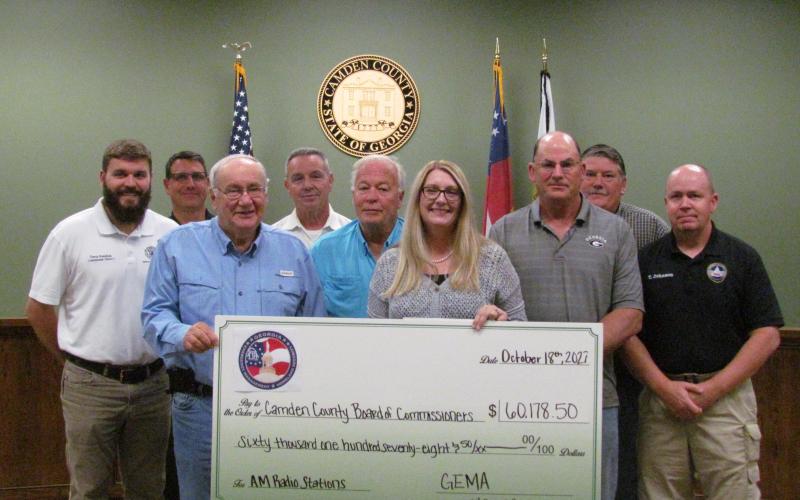 Camden County commissioners celebrate a grant award with Camden County Radio System Administrator Bill Carreira, EMA Director Chuck White, Grants Manager Julie Haigler and EMA Deputy Director Troy Johnson.