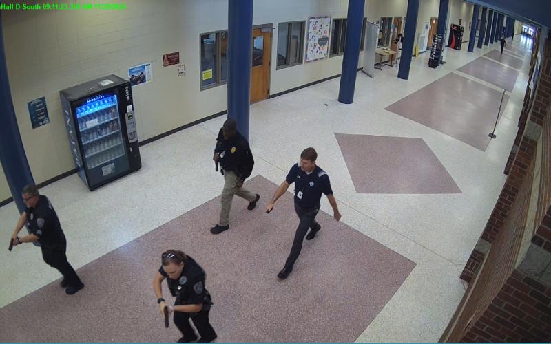 Still shots from security cameras inside Camden County High School show law enforcement officials searching the school for a shooter Nov. 30. Reports of a shooting at the school were a hoax.