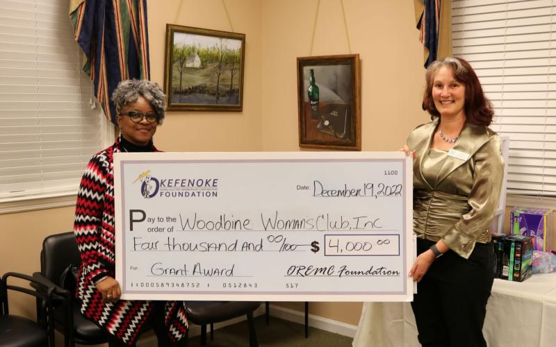 Ginger Readdick, president of the Woodbine Woman’s Club, receives a grant from OREMC Foundation Trustee Sonya Walker to support the Community Jazz and Art Festival. 