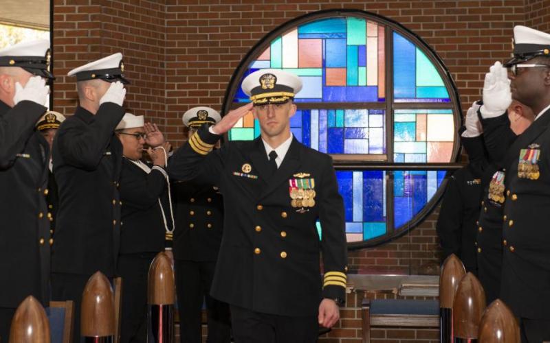 Cmdr. James Kepper IV, incoming commanding officer of the Ohio-class ballistic-missile submarine USS West Virginia (SSBN 736) Blue Crew, salutes the side boys during a change of command ceremony at the chapel onboard Naval Submarine Base Kings Bay.